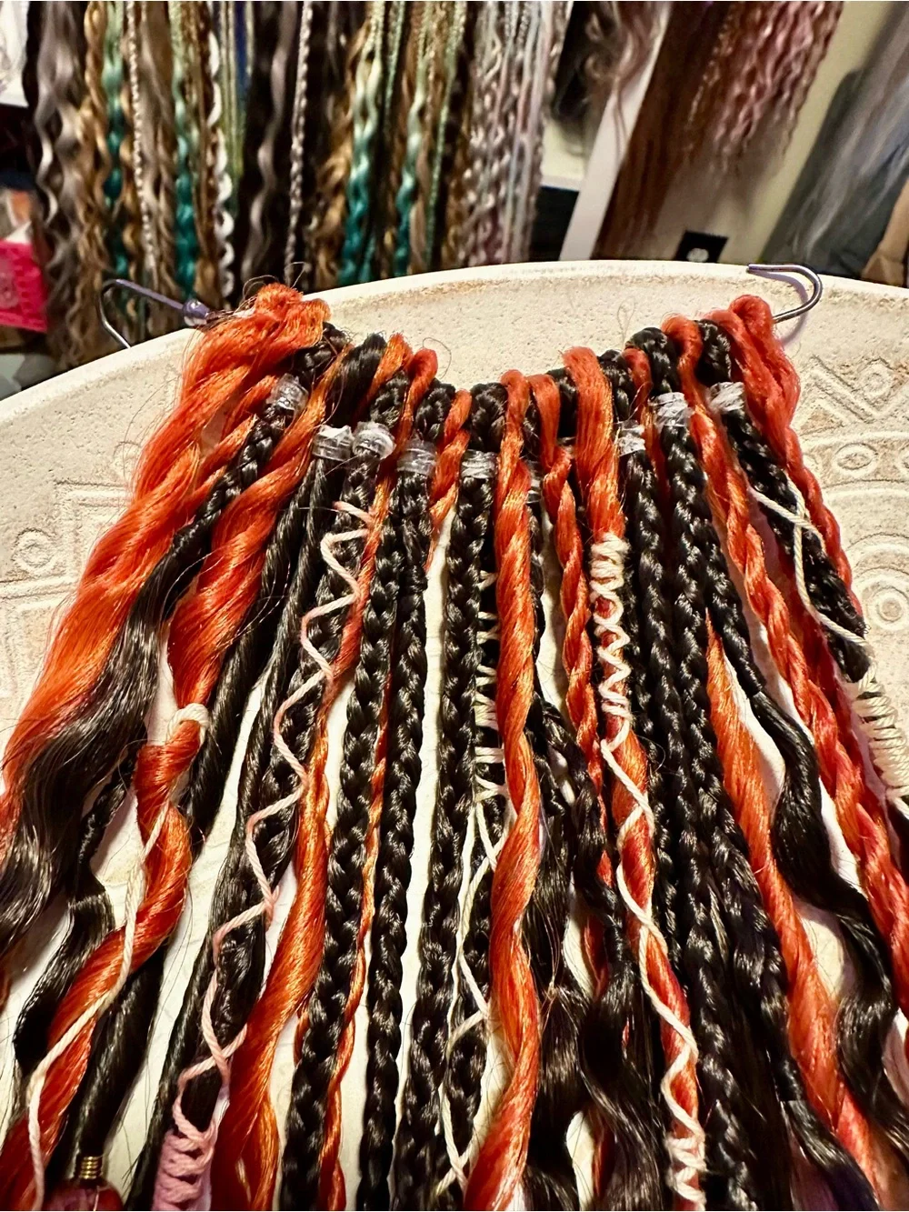 Blonde Hair Extensions with Black and Orange Braided Accents
